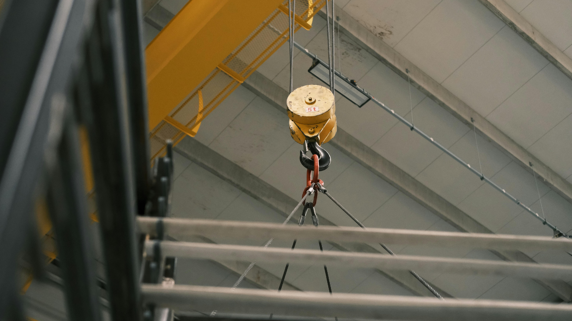 Overhead crane in operation with safety measures in place